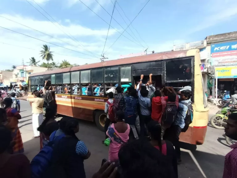 Students on the bus are Dangling from the Steps.